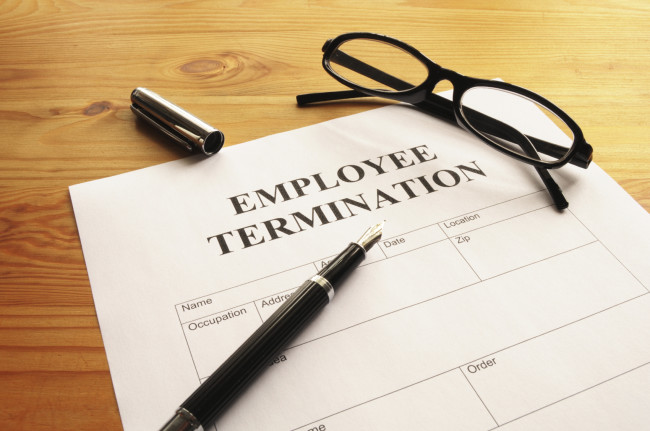 employee termination form on desk in business office showing job concept